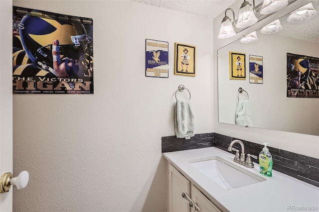 bathroom featuring a textured ceiling and vanity