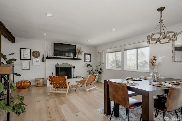 8559 W 75th Pl, Arvada, CO 80005 - dining space with a chandelier, light wood finished floors, recessed lighting, a fireplace, and baseboards
