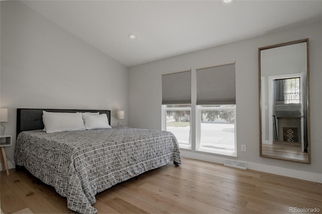 8559 W 75th Pl, Arvada, CO 80005 - bedroom featuring wood finished floors, recessed lighting, and vaulted ceiling
