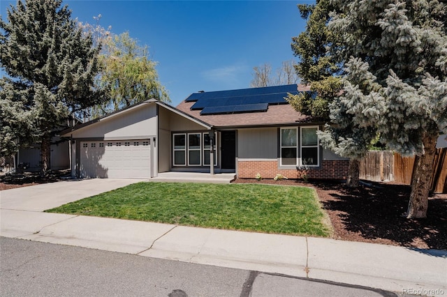 8559 W 75th Pl, Arvada, CO 80005 - ranch-style house with brick siding, a garage, roof mounted solar panels, a shingled roof, and concrete driveway