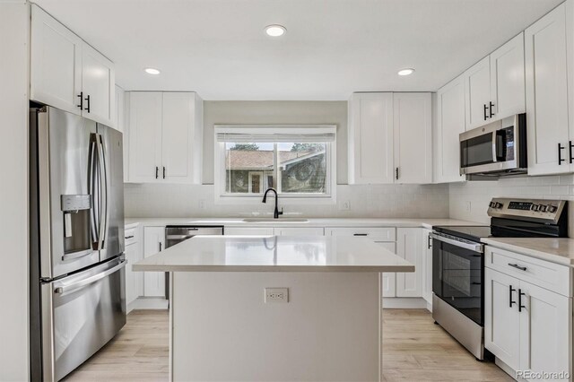 46 Douglas Dr, Broomfield, CO 80020 - kitchen featuring stainless steel appliances, decorative backsplash, light countertops, light wood-type flooring, and recessed lighting