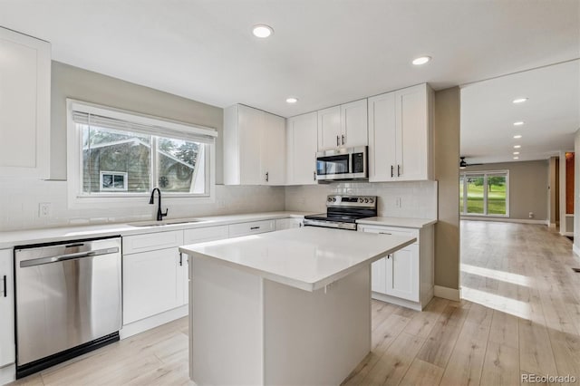 46 Douglas Dr, Broomfield, CO 80020 - kitchen featuring stainless steel appliances, light countertops, backsplash, recessed lighting, and white cabinets