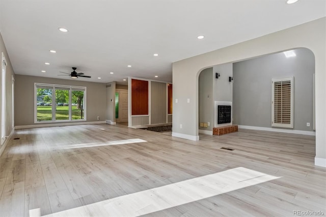 46 Douglas Dr, Broomfield, CO 80020 - unfurnished living room featuring arched walkways, a ceiling fan, recessed lighting, and light wood-style floors