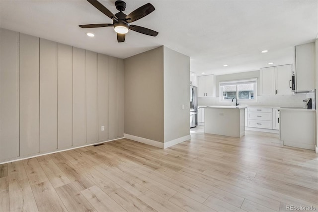 46 Douglas Dr, Broomfield, CO 80020 - unfurnished living room featuring a ceiling fan, light wood finished floors, and recessed lighting