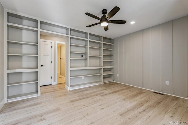 46 Douglas Dr, Broomfield, CO 80020 - unfurnished bedroom featuring wood finished floors, recessed lighting, a ceiling fan, a decorative wall, and connected bathroom