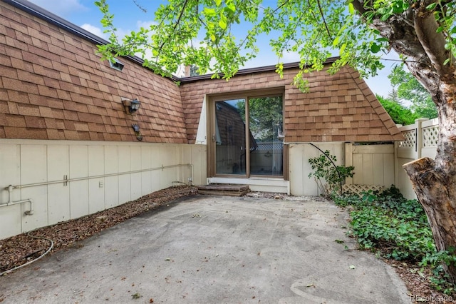 46 Douglas Dr, Broomfield, CO 80020 - entrance to property featuring roof with shingles, a patio area, and mansard roof
