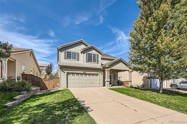 view of front of property featuring a garage and a front yard