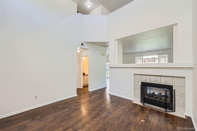 unfurnished living room with wood-type flooring and a fireplace