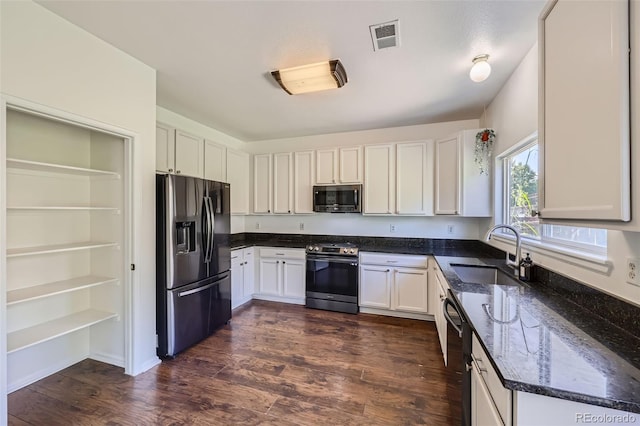 kitchen featuring dark wood-type flooring, stainless steel appliances, sink, and white cabinets