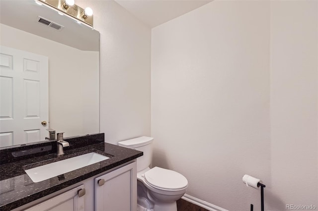 bathroom featuring toilet and vanity