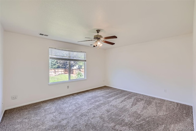 carpeted spare room with ceiling fan