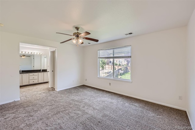 interior space featuring ceiling fan and carpet