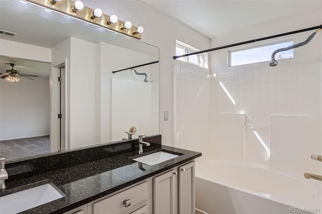 bathroom with vanity, ceiling fan, and shower / washtub combination