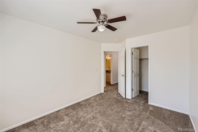 unfurnished bedroom with ceiling fan, dark colored carpet, and a closet