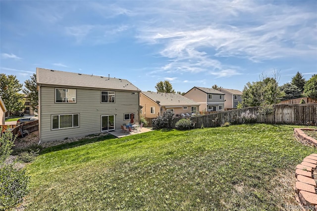 back of house featuring a yard and a patio