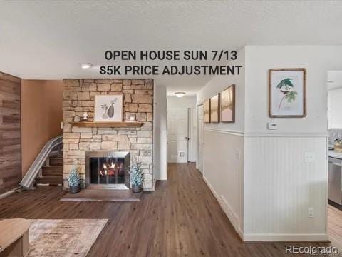 1935 W 102nd Ave, Thornton, CO 80260 - unfurnished living room with wood finished floors, a stone fireplace, and wood walls
