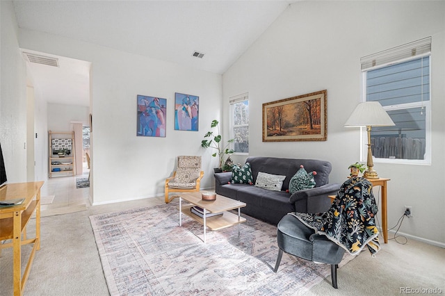 carpeted living room featuring high vaulted ceiling