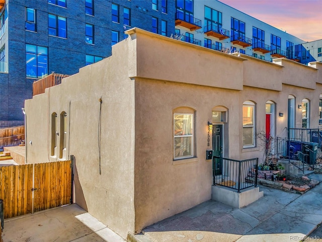 exterior space featuring fence and stucco siding