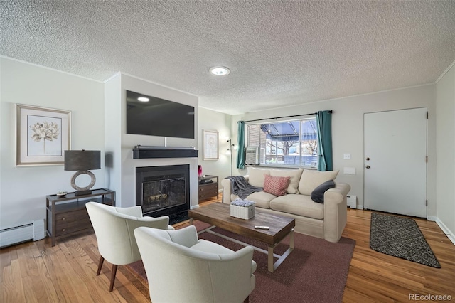 living room featuring a textured ceiling and light hardwood / wood-style flooring