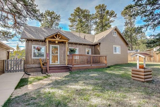 view of front facade with a front yard and a wooden deck