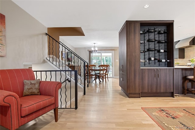 1615 Violet St, Golden, CO 80401 - bar area featuring light wood-type flooring, decorative backsplash, a chandelier, stairway, and recessed lighting