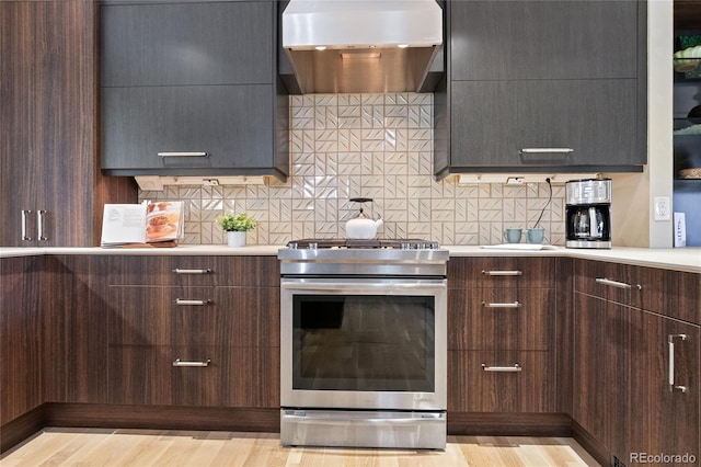 1615 Violet St, Golden, CO 80401 - kitchen featuring stainless steel range with gas stovetop, wall chimney exhaust hood, modern cabinets, and light wood-type flooring