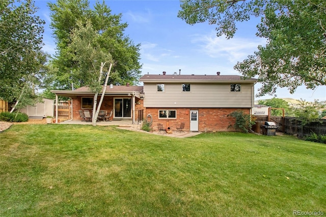 1615 Violet St, Golden, CO 80401 - back of property featuring brick siding, a patio, and a fenced backyard