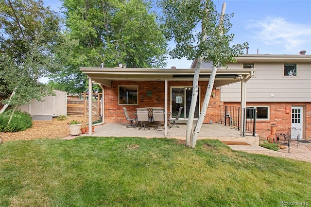 1615 Violet St, Golden, CO 80401 - back of property featuring brick siding and a patio area