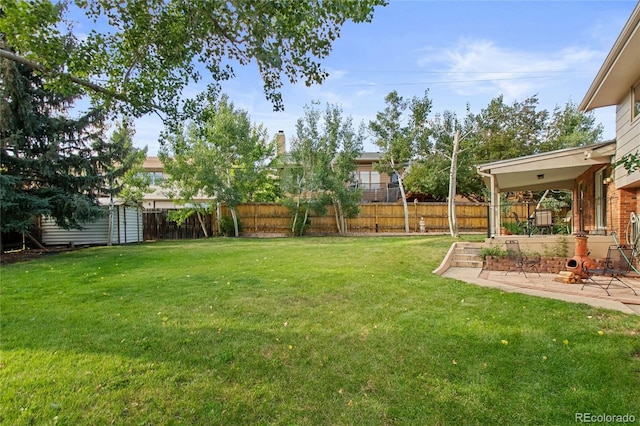 1615 Violet St, Golden, CO 80401 - fenced backyard featuring a patio area and a storage unit