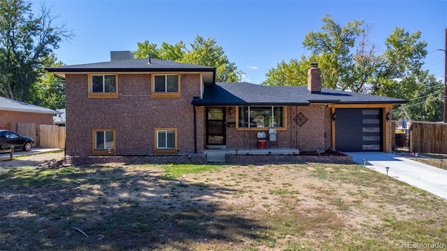 view of front of home with a garage and a front lawn