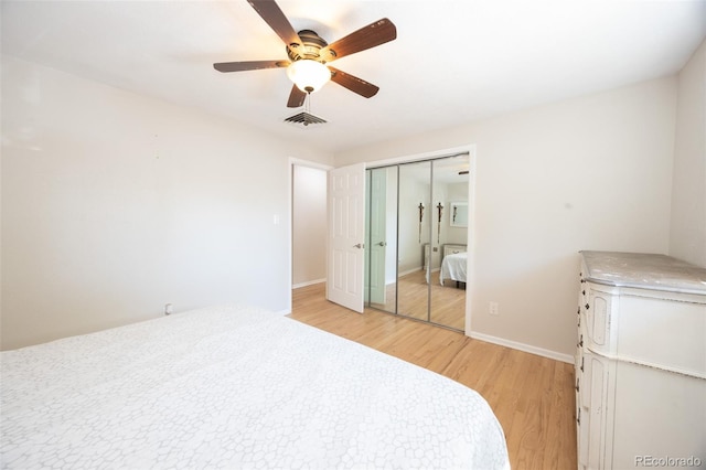 bedroom with ceiling fan, a closet, and light hardwood / wood-style floors