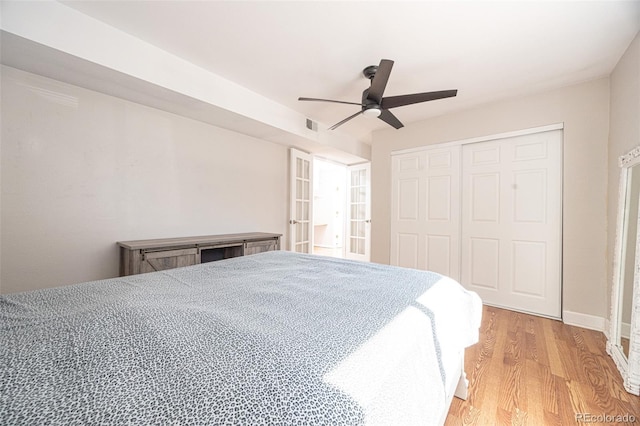 bedroom featuring ceiling fan, a closet, and light hardwood / wood-style flooring