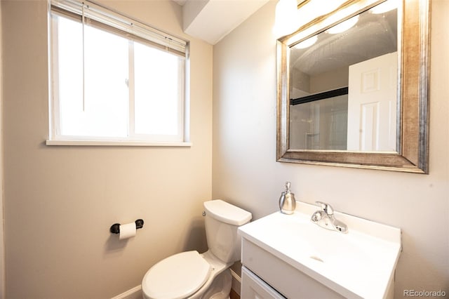 bathroom featuring walk in shower, vanity, and toilet