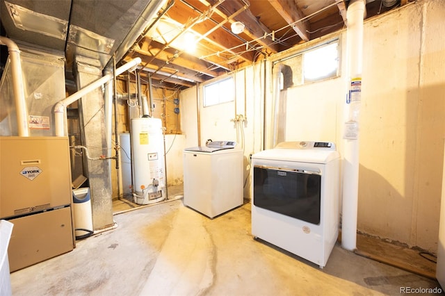 basement featuring water heater and washer and dryer