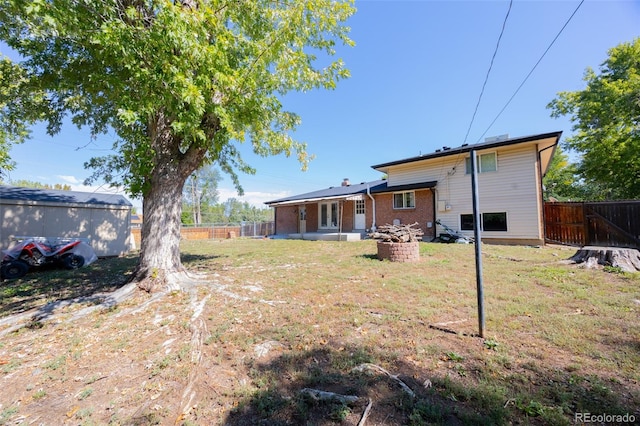 back of house with a lawn