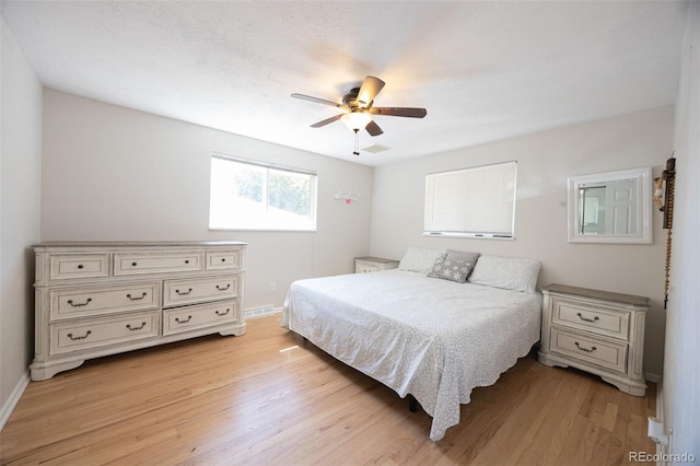 bedroom with ceiling fan and light hardwood / wood-style floors