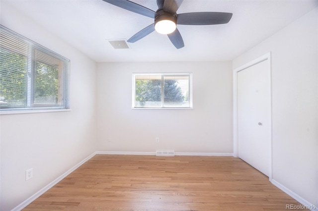 spare room with ceiling fan and light wood-type flooring