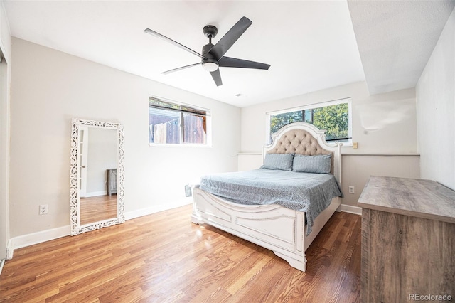 bedroom with hardwood / wood-style floors and ceiling fan