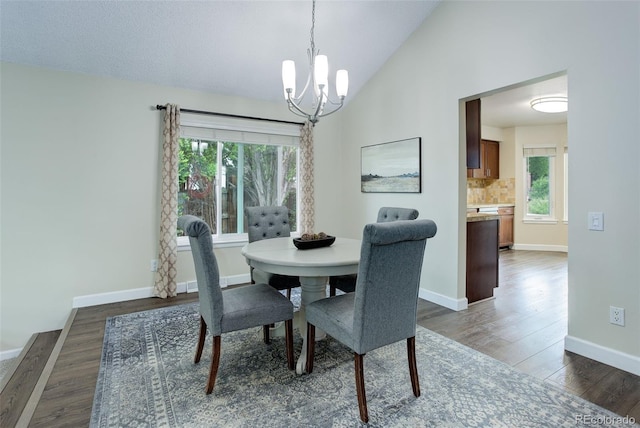10966 W Half Moon Pass, Littleton, CO 80127 - dining room featuring a chandelier, dark wood finished floors, baseboards, and vaulted ceiling