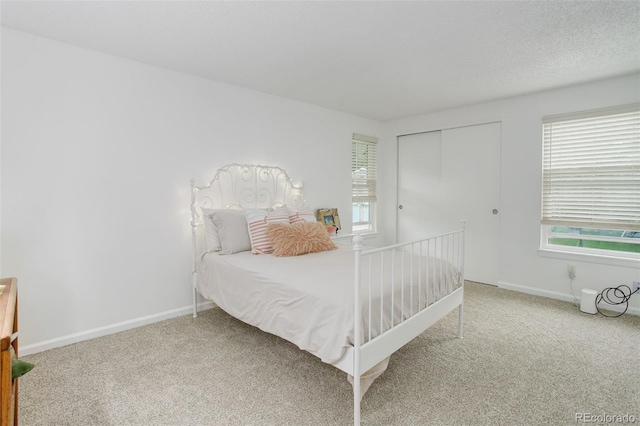 10966 W Half Moon Pass, Littleton, CO 80127 - bedroom featuring carpet floors, multiple windows, a closet, and baseboards
