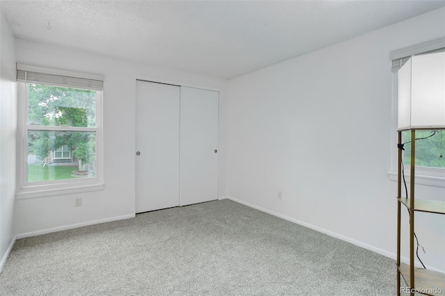 10966 W Half Moon Pass, Littleton, CO 80127 - unfurnished bedroom featuring carpet floors, baseboards, and a closet
