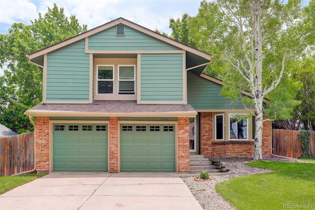 10966 W Half Moon Pass, Littleton, CO 80127 - view of front of house featuring brick siding, concrete driveway, and an attached garage