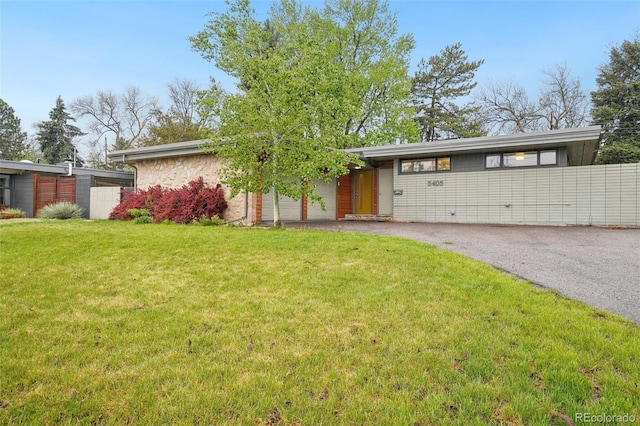 5405 S Lowell Blvd, Littleton, CO 80123 - view of front of house featuring asphalt driveway, a front yard, and a garage