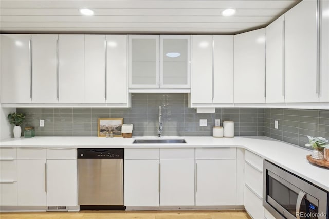 5405 S Lowell Blvd, Littleton, CO 80123 - kitchen featuring appliances with stainless steel finishes, a sink, light countertops, white cabinetry, and recessed lighting