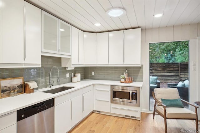5405 S Lowell Blvd, Littleton, CO 80123 - kitchen featuring appliances with stainless steel finishes, a sink, light wood-style floors, white cabinets, and wood ceiling