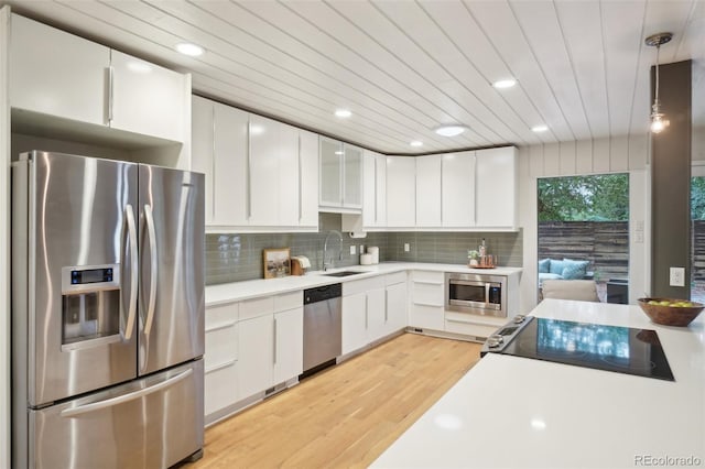 5405 S Lowell Blvd, Littleton, CO 80123 - kitchen featuring appliances with stainless steel finishes, a sink, light countertops, white cabinetry, and wood ceiling