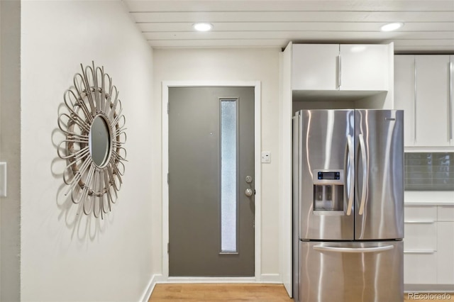 5405 S Lowell Blvd, Littleton, CO 80123 - kitchen featuring stainless steel fridge, recessed lighting, white cabinets, light wood finished floors, and decorative backsplash