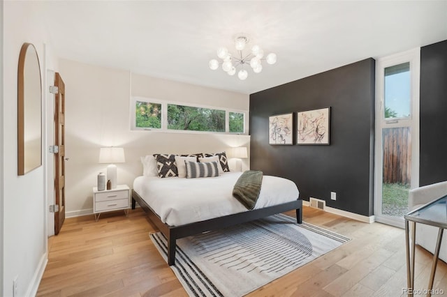5405 S Lowell Blvd, Littleton, CO 80123 - bedroom with light wood-style flooring, a chandelier, baseboards, and access to exterior