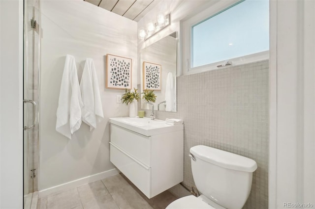 5405 S Lowell Blvd, Littleton, CO 80123 - full bathroom featuring toilet, a shower with shower door, vanity, tile walls, and tile patterned floors