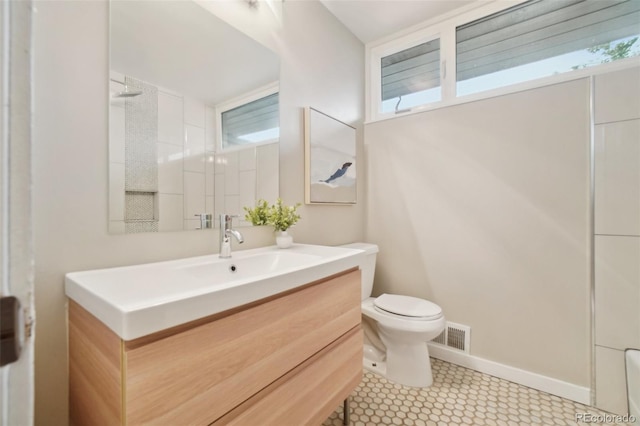 5405 S Lowell Blvd, Littleton, CO 80123 - bathroom featuring toilet, vanity, a shower, and baseboards
